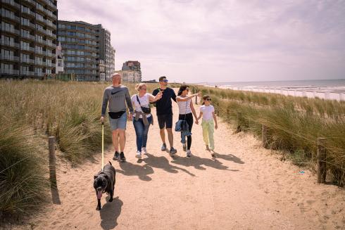 Wandelen tussen het helmgras. Een wandelpad door de groene grasdijk maakt het mogelijk om veel eerder op de dag van de zon te genieten. © Luc Cassiman Wandelen tussen het helmgras. Een wandelpad door de groene grasdijk maakt het mogelijk om veel eerder op de dag van de zon te genieten. © Luc Cassiman